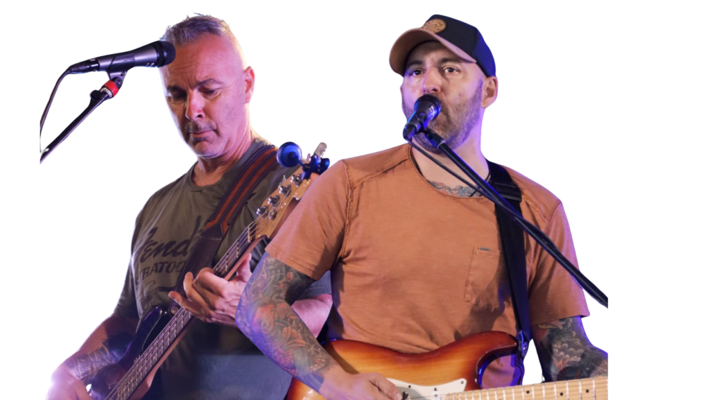 Deux musiciens chantent et jouent de la guitare sur scène lors d’un spectacle.